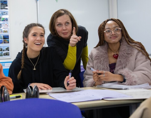 Teacher with two students in Business class