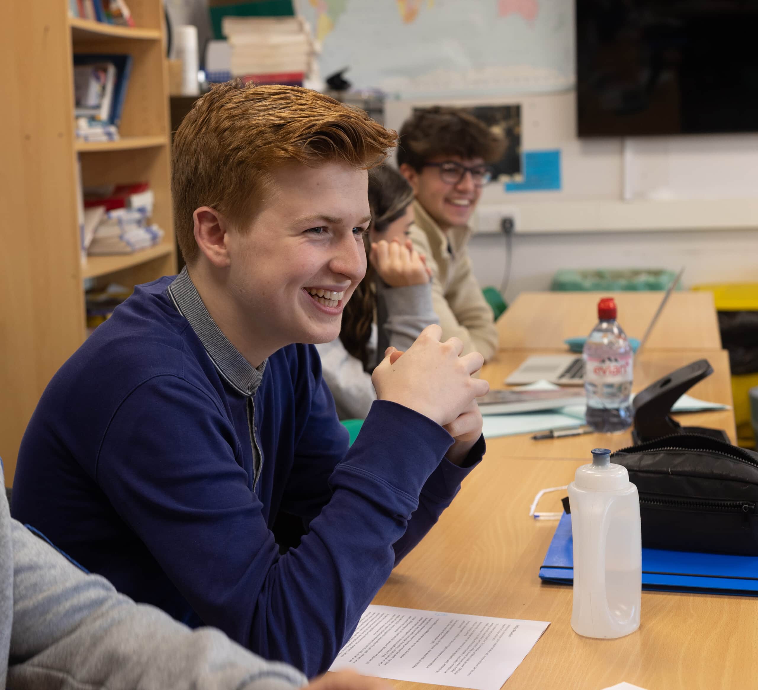 Boy smiling in Politics class