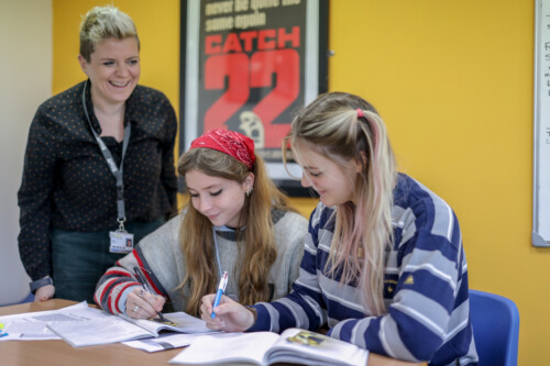 English Literature Teacher Nat Helping Two Female Students