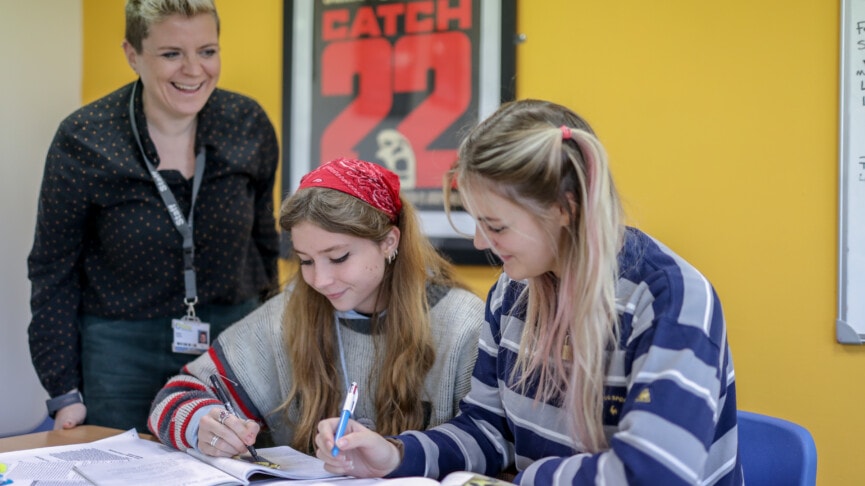 English Literature Teacher Nat Helping Two Female Students