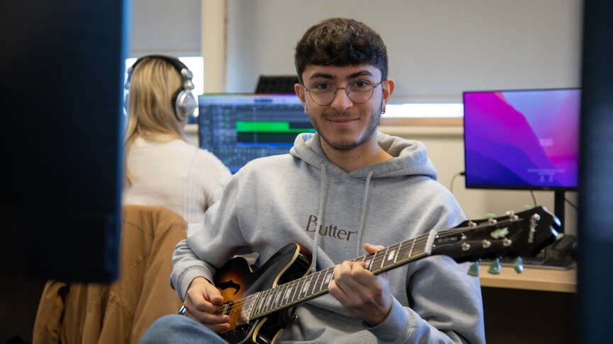 Boy holding a guitar