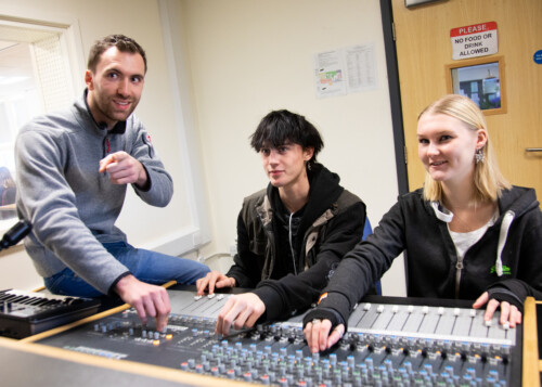 teacher with students in recording studio