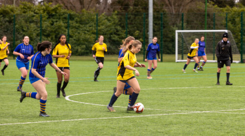 Women playing football at Esher