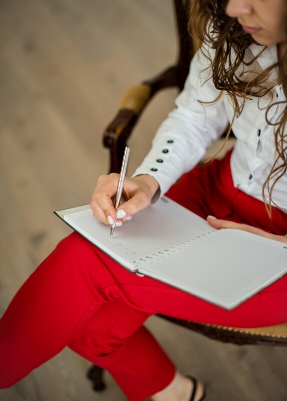 Lady writing in a book